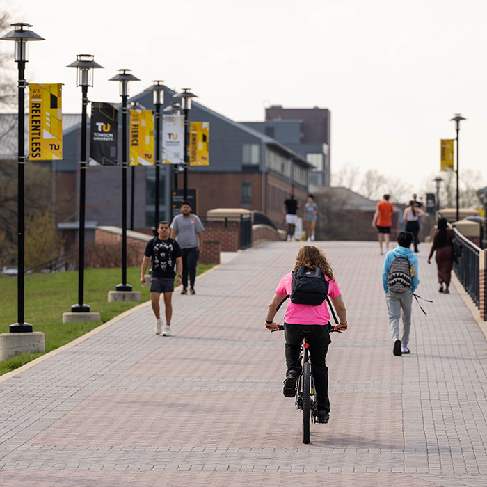Student rides a bike on TU campus