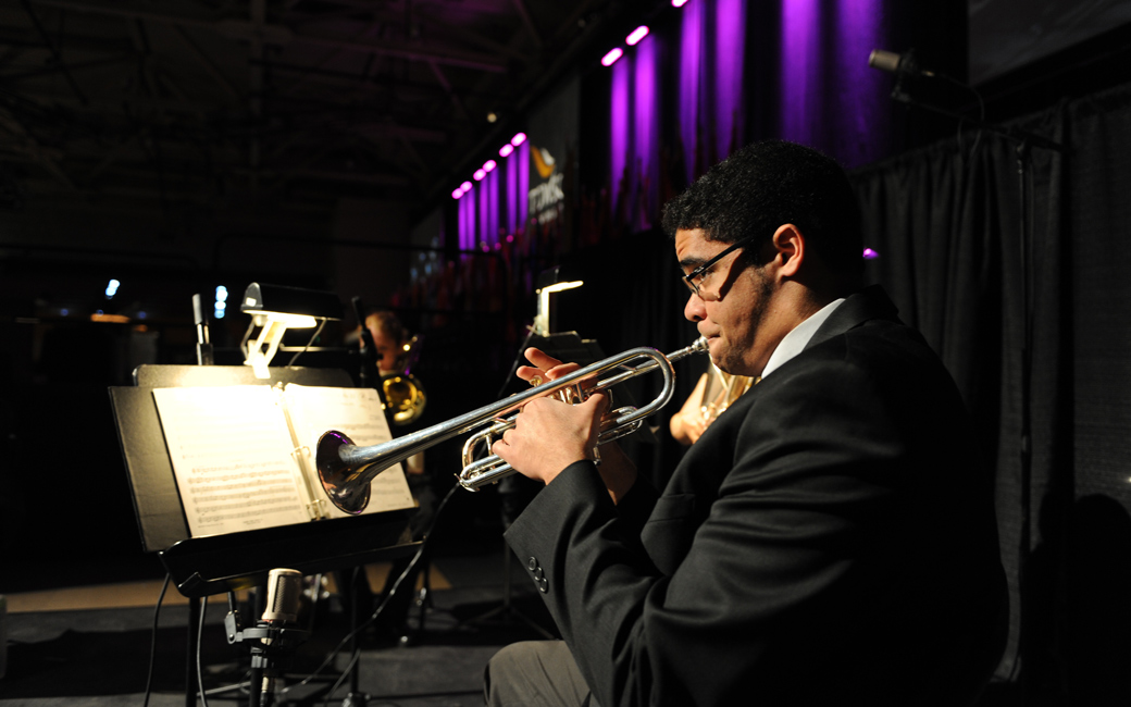A student musician skillfully plays the trumpet during a concert