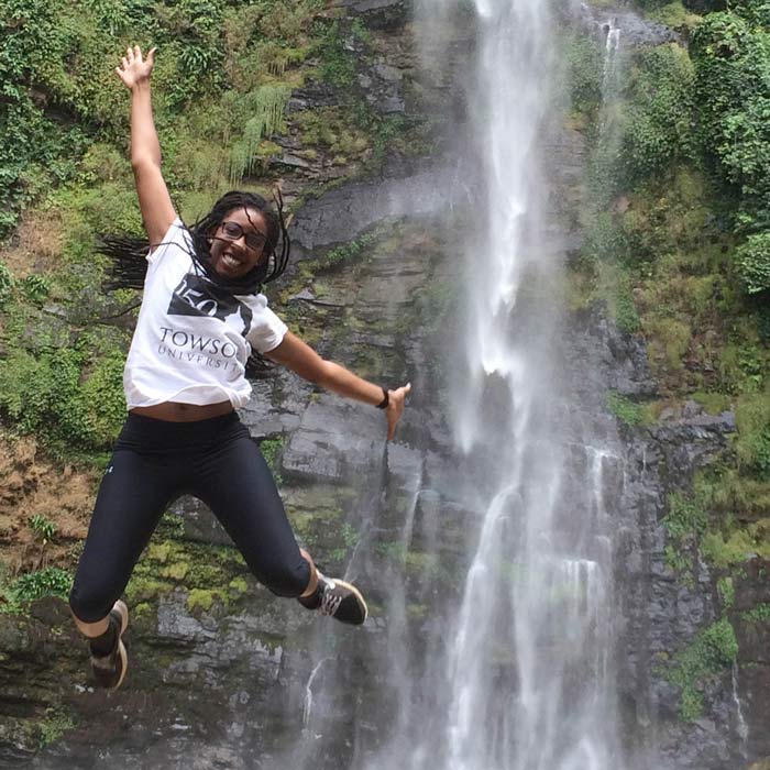 Student at waterfall in Ghana