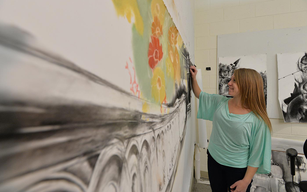 Student artist drawing on board