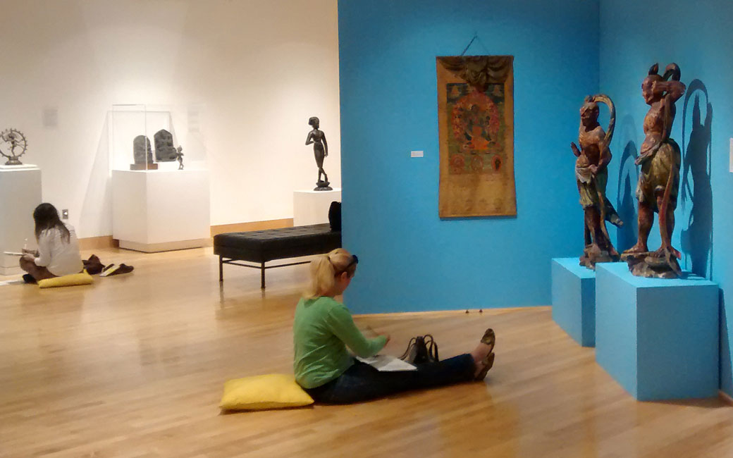 A student studies the Meditation exhibition in the Asian Arts Gallery