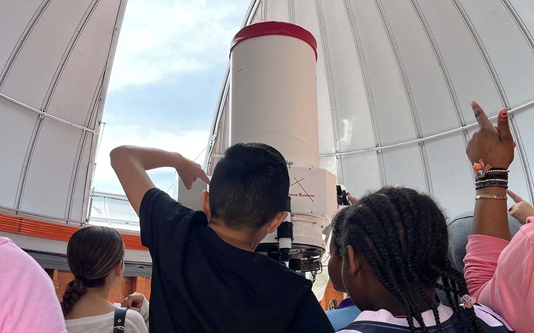 Middle school students from Loch Raven Technical Academy explore how to use a telescope at the Science Complex