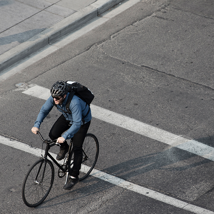 high angle view of male commuter riding a bicycle to work