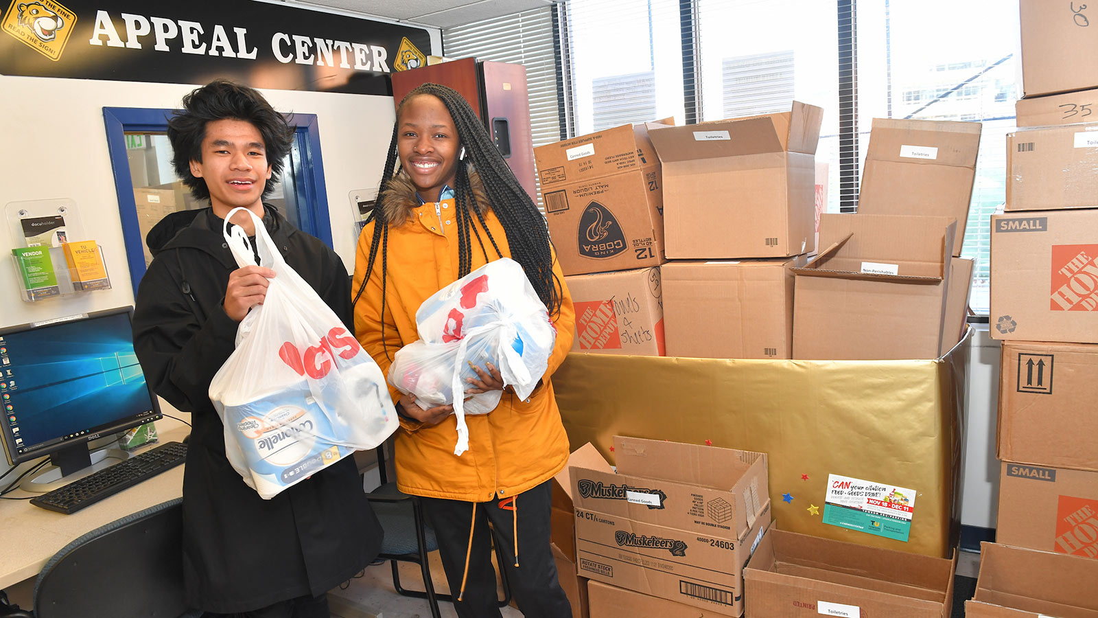 Two people holding bags of food
