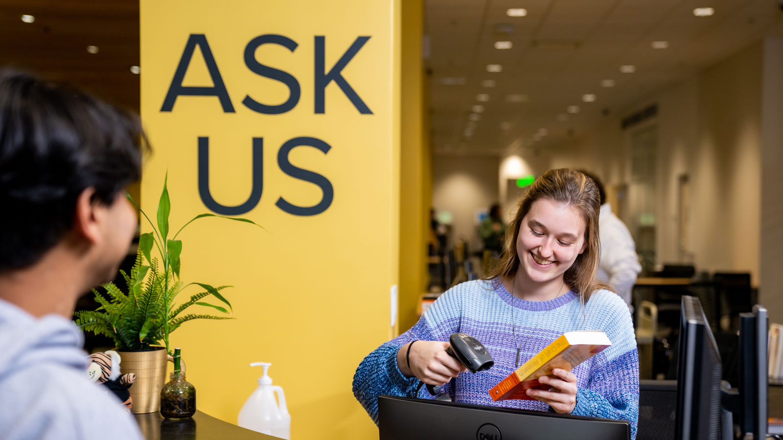 Student checking out a book from the library