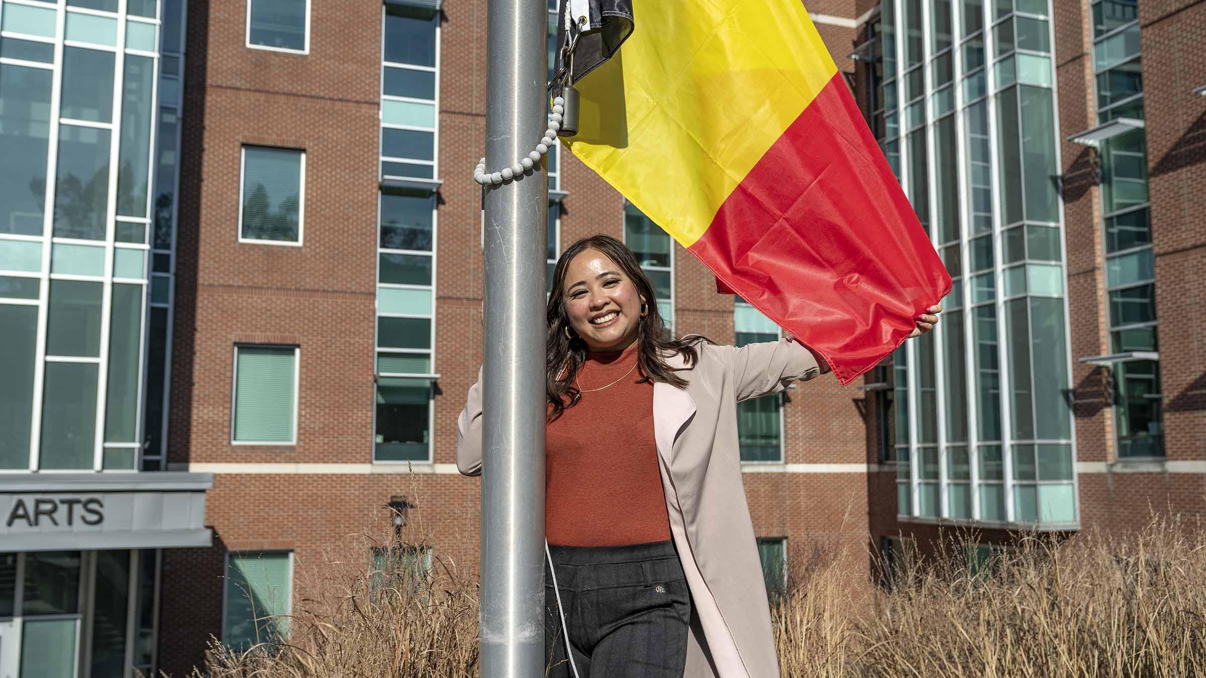 TU student holding the Belgian flag