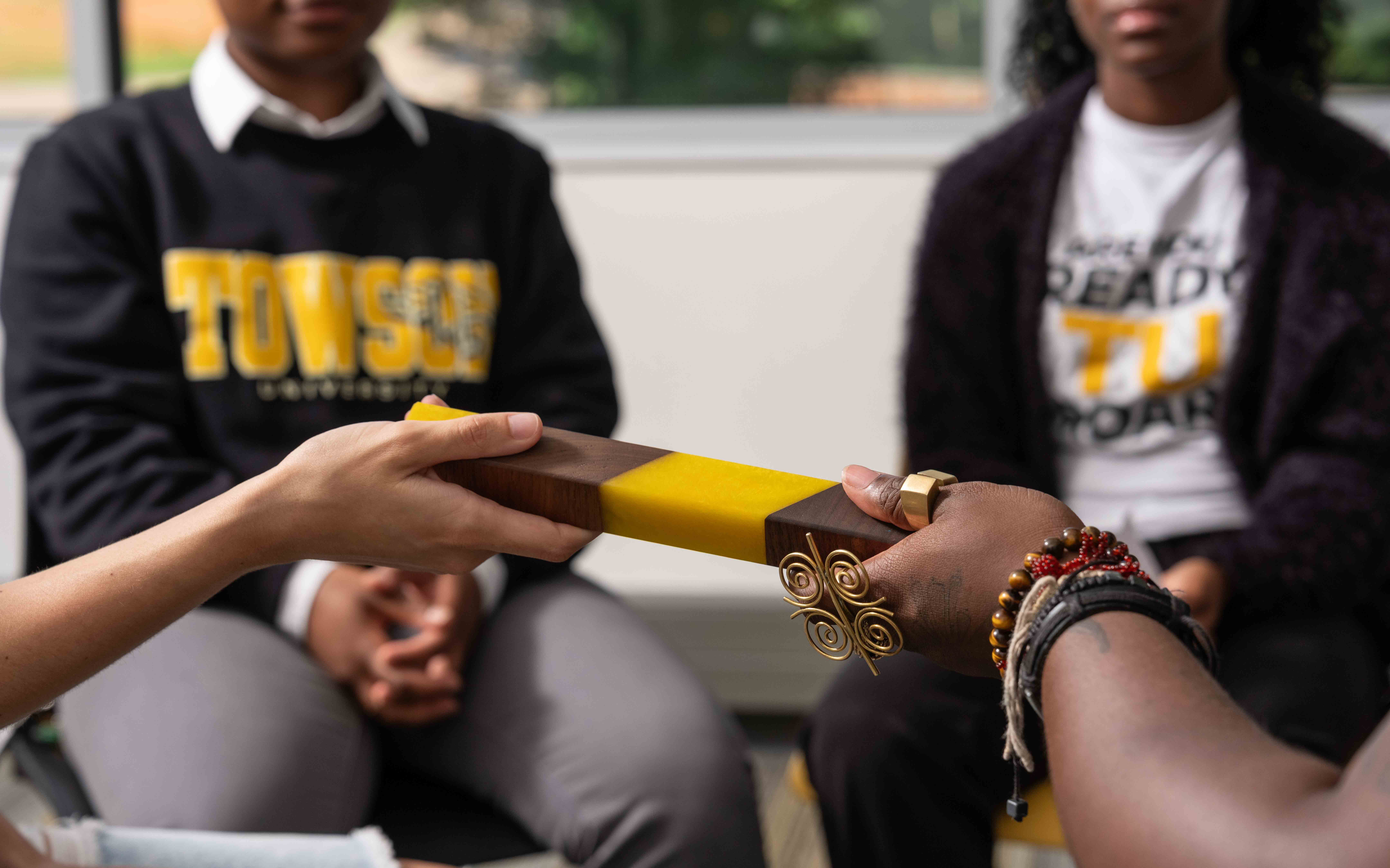 students pass talking piece around circle