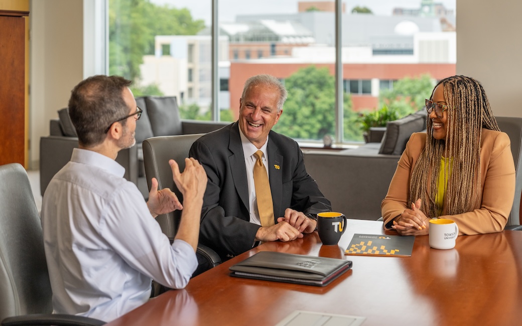 president ginsberg in discussion with staff members