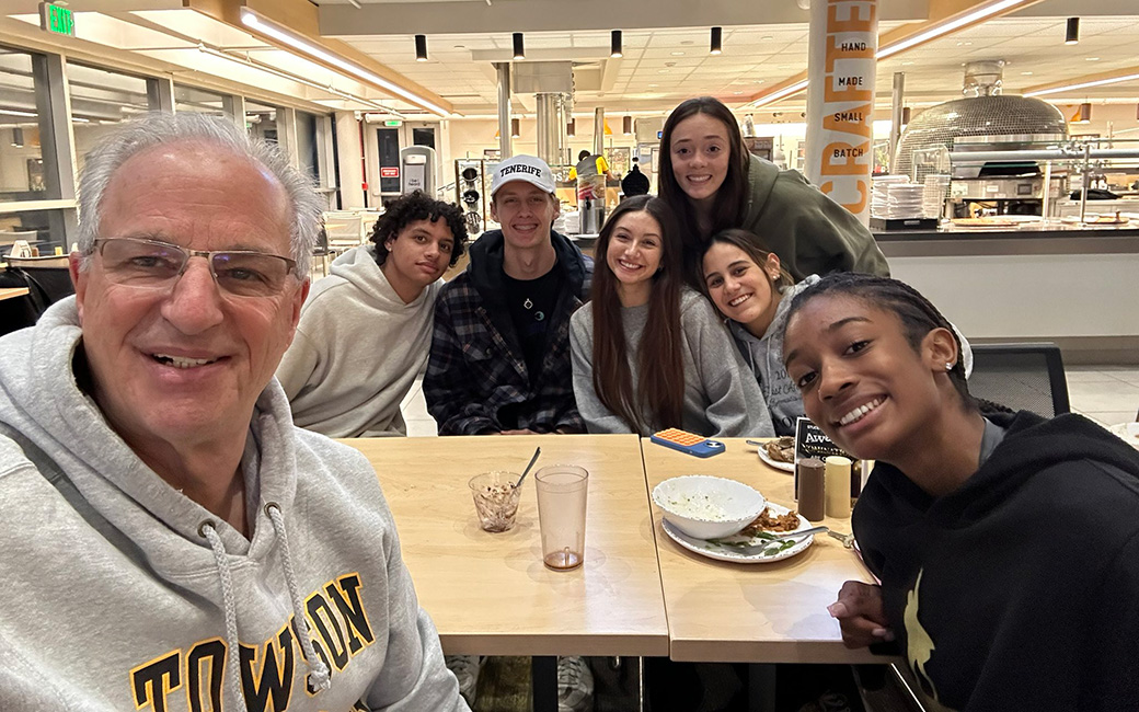 TU president Mark Ginsberg with TU students in the dining hall