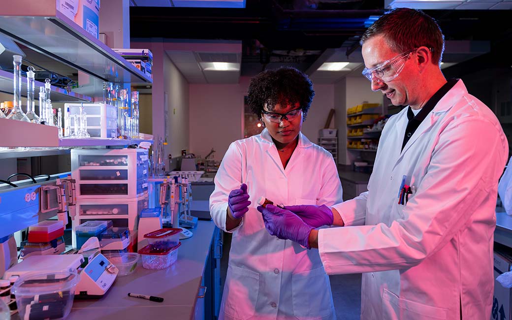 Student and faculty member working in a chemistry lab