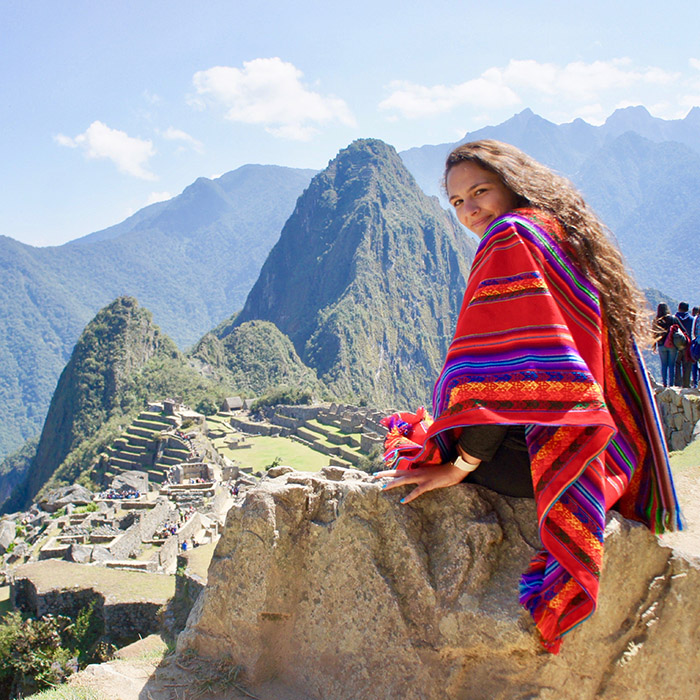 Young woman posing by Machu Picchu