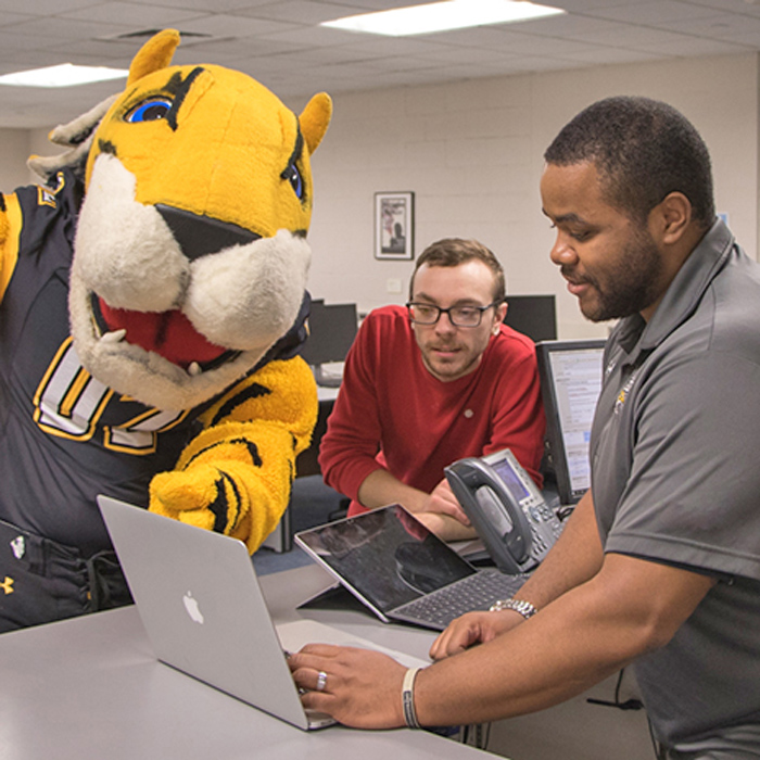 mascot and student assisted at the SCS service desk