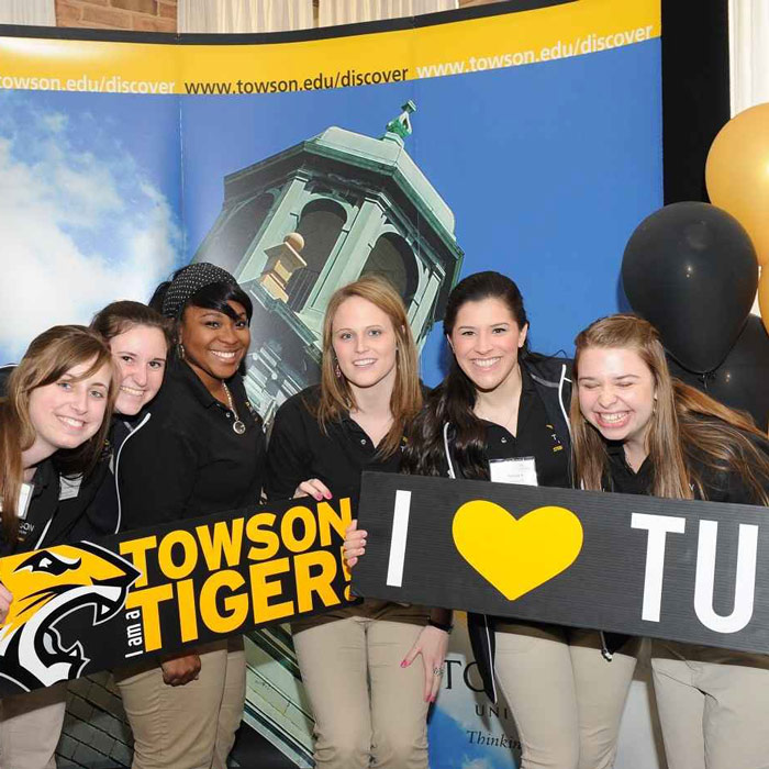 students with Towson signs
