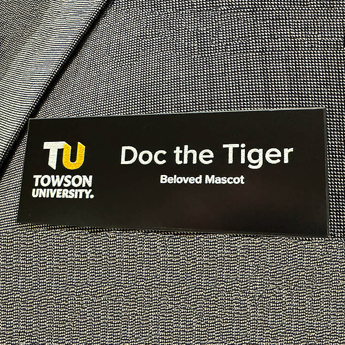 A TU badge pinned on a sportscoat