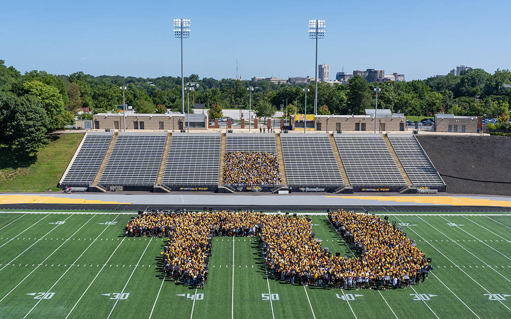 Students on the TU football field in the shape of a T and U