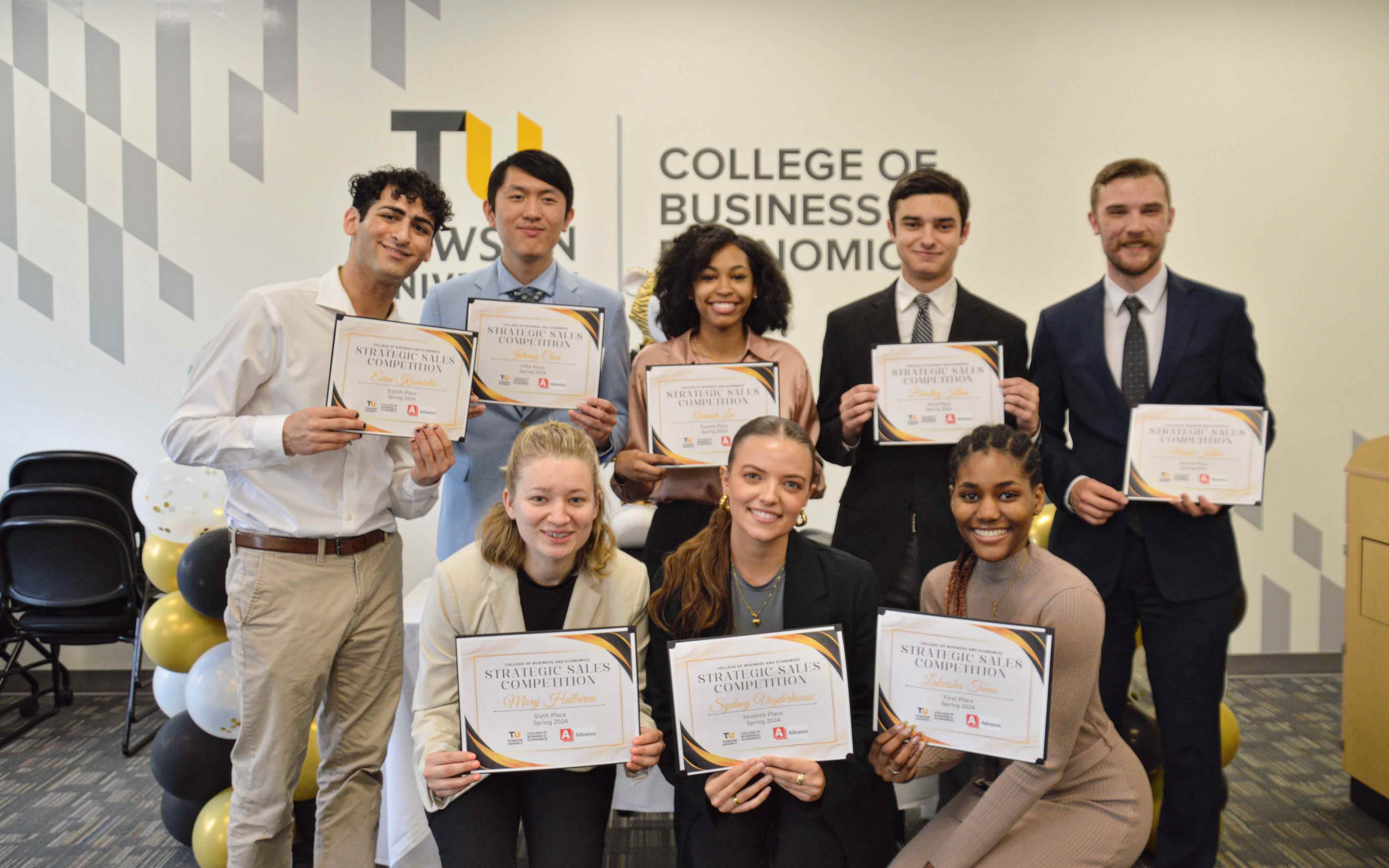 Students pose with their winning certificates