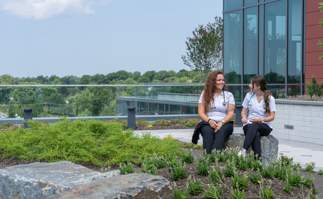 TU nursing students sitting on a rooftop garden