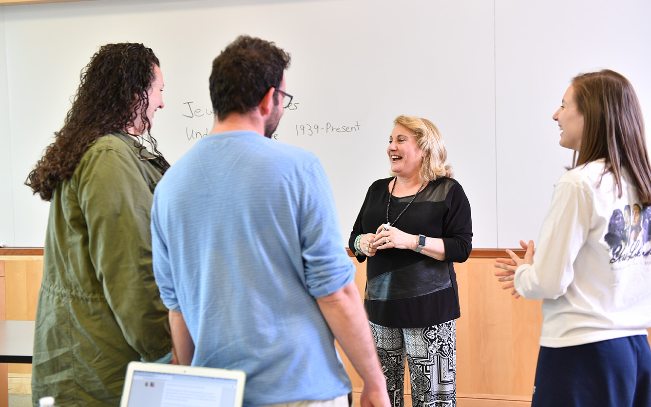 founding director Dr. Bor works directly with a student at a table