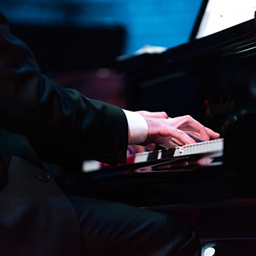 Close up on piano player