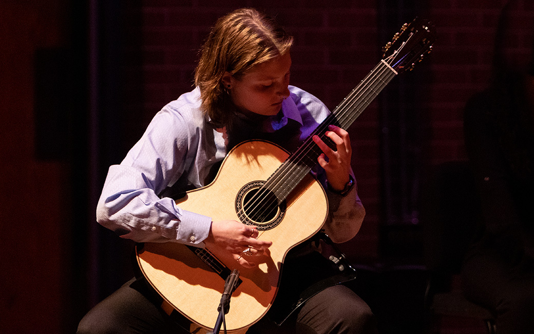 TU student playing a guitar