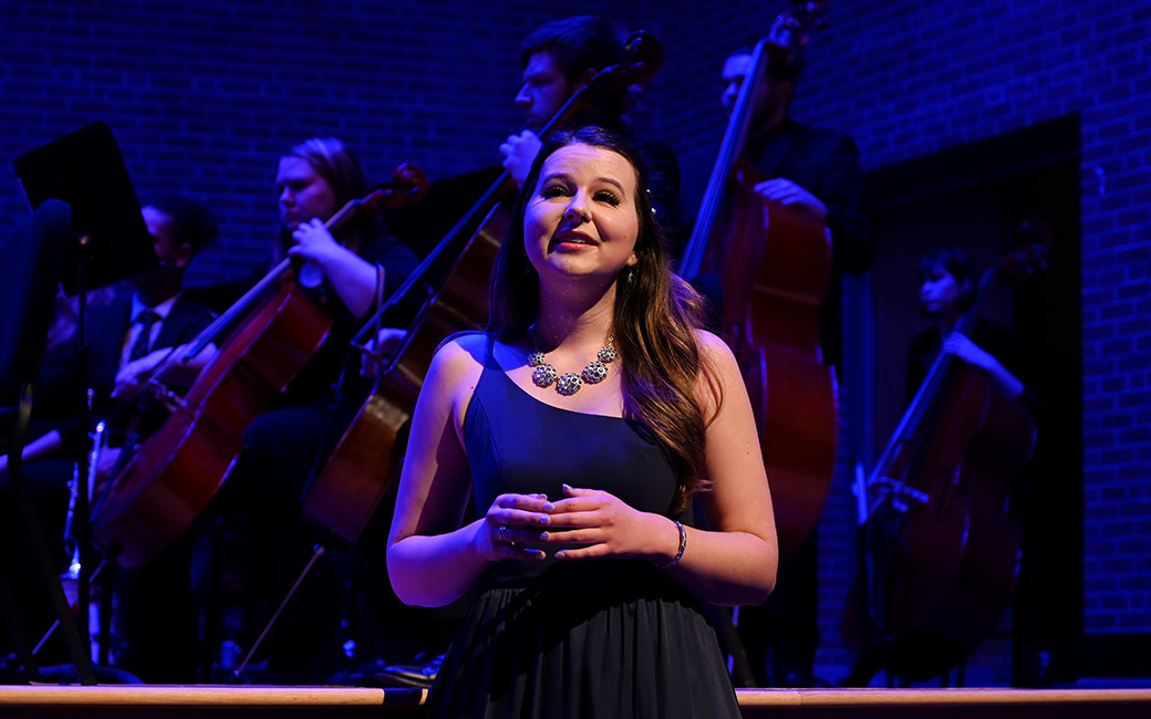 Female performer singing on stage