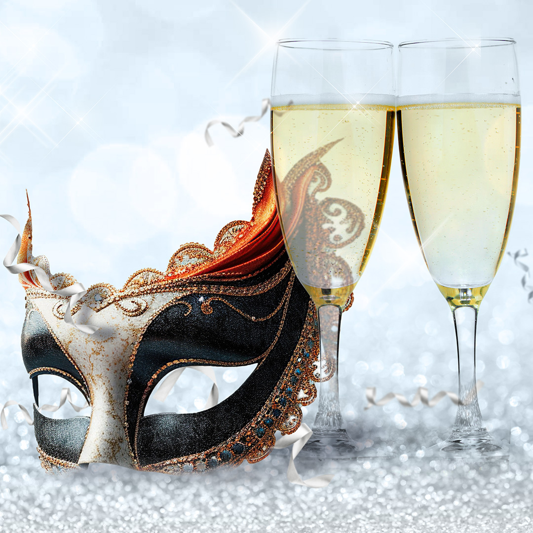 A close up on a party mask and champagne flutes 