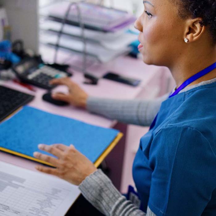 medical biller working on a computer