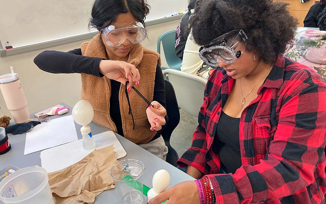 high school students performing science experiment