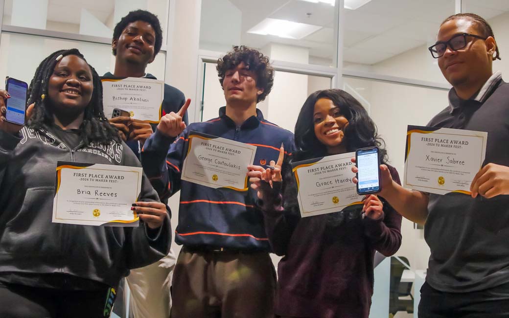 students pose with certificates