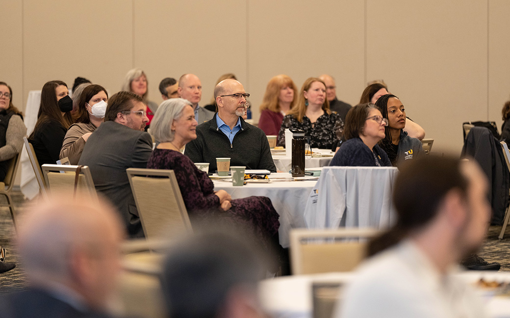 Crowd sitting and listening to a presentation