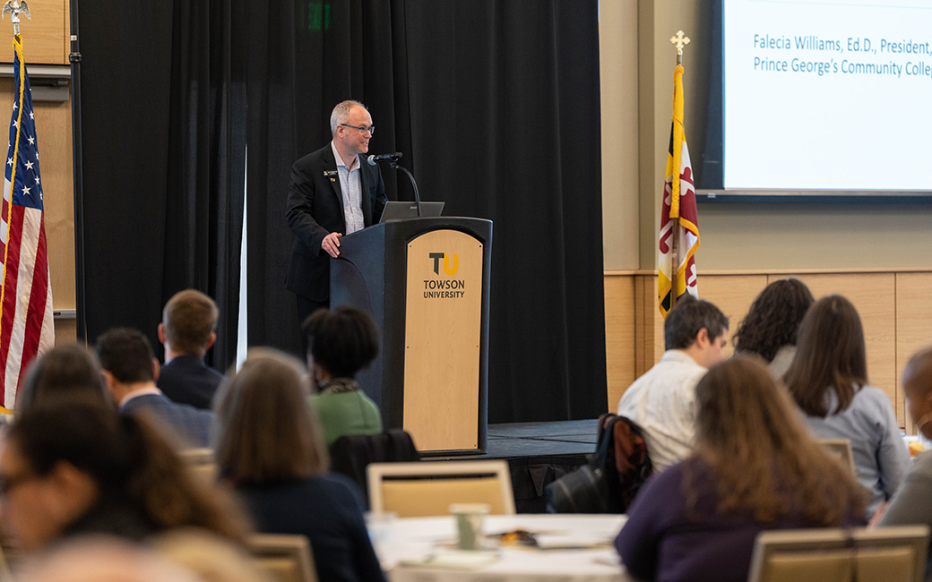 TU employee speaking on a stage