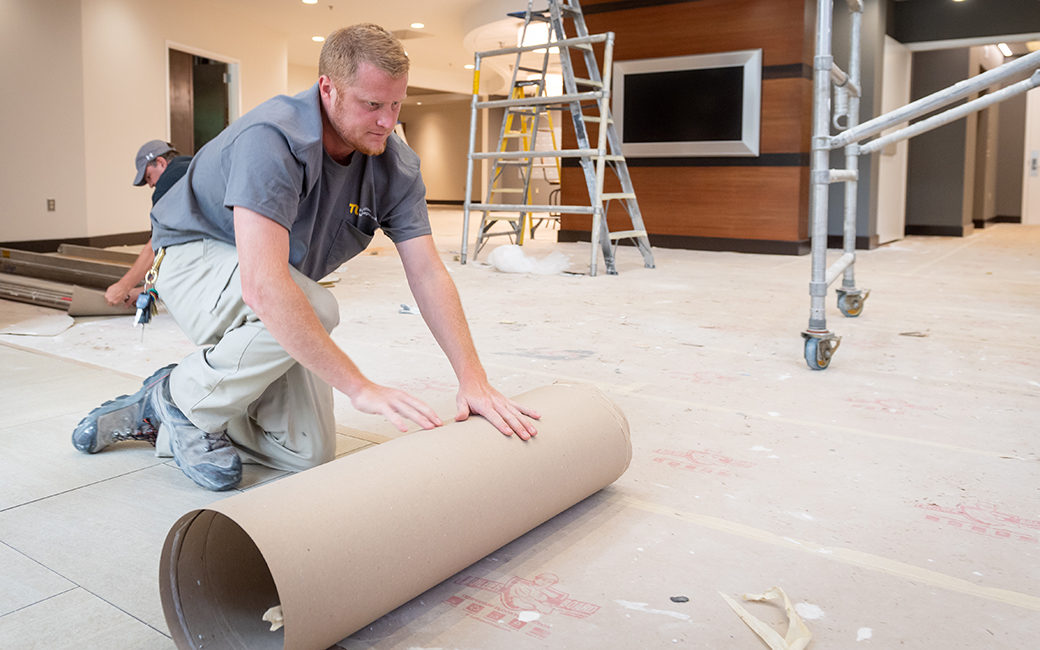 TU employee installing a floor