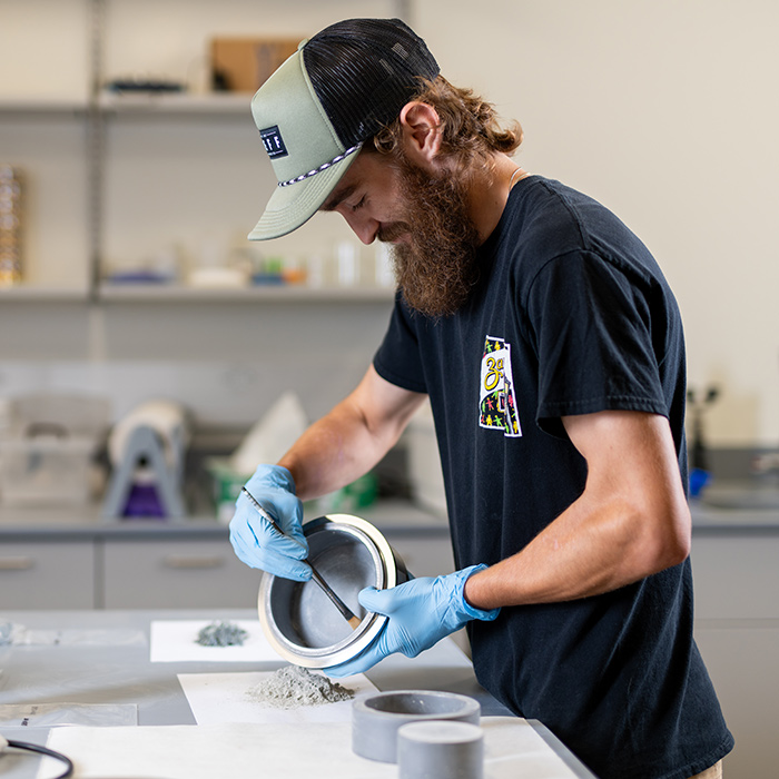 Evan Powell powdering geological samples using the Spex Shatterbox with tungsten carbide grinding 