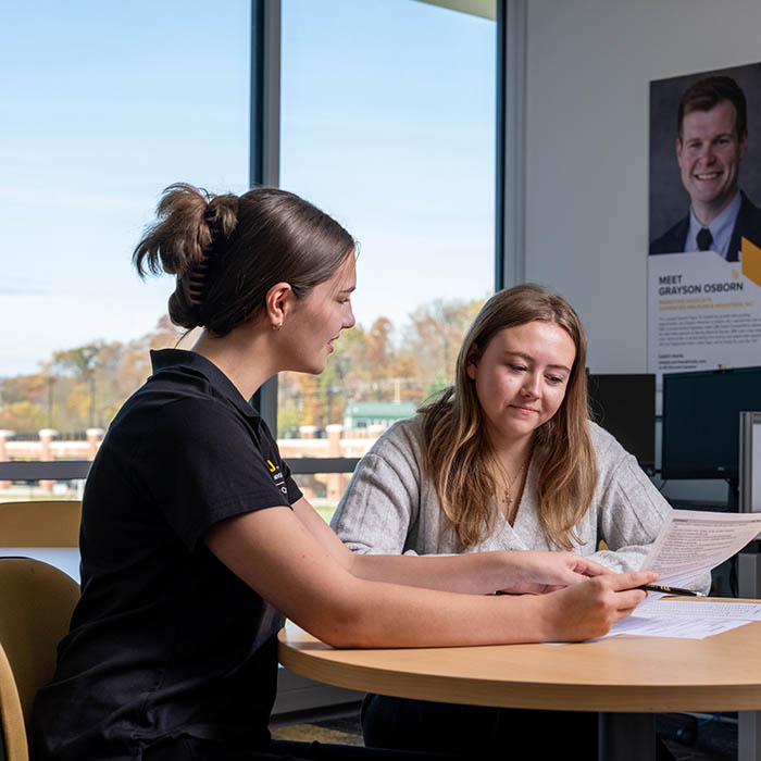 Student worker coaching another student