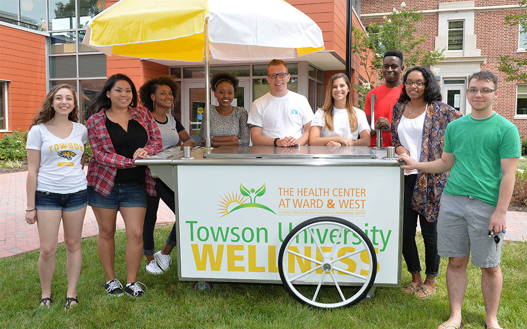 Students standing around a wellness cart