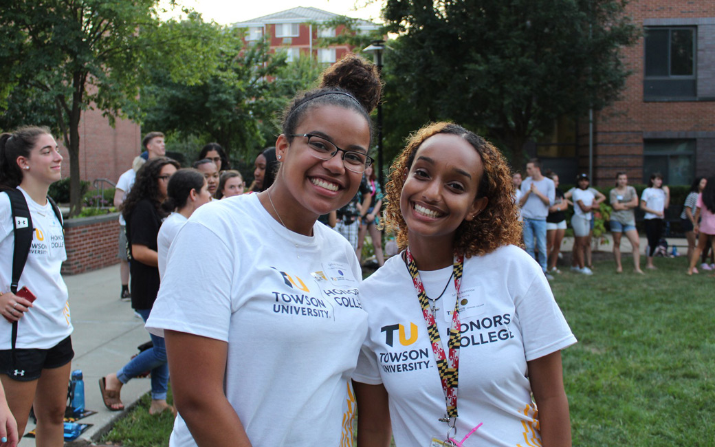 Two Honors Orientation Mentors smiling in front of Orientation participants