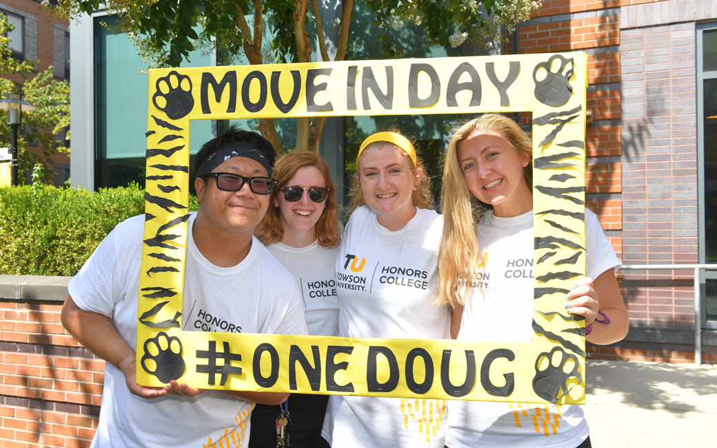 Orientation Mentors standing outside Douglass House with welcome sign