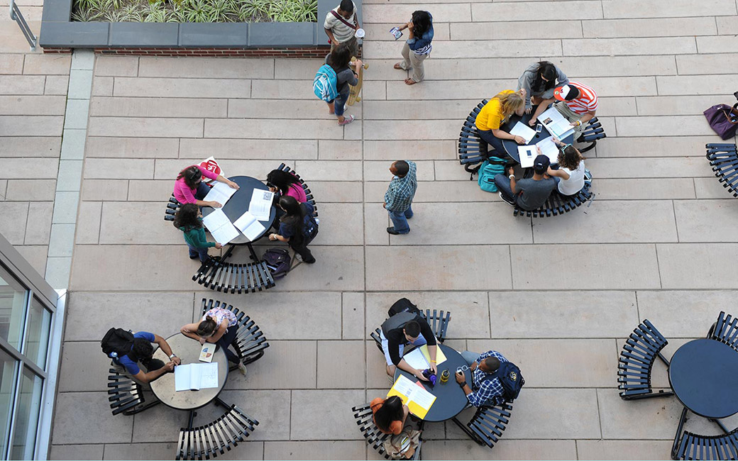 Air view of students sitting at picnic tables on campus