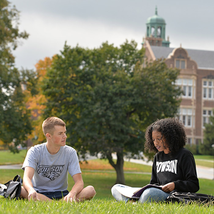 Students sitting on a hill on campus