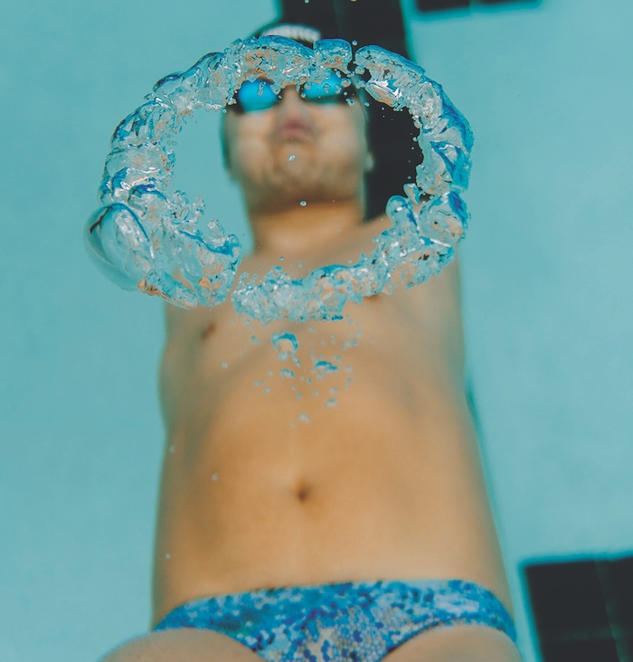 Marty Hendrick swimming underwater and blowing a bubble ring