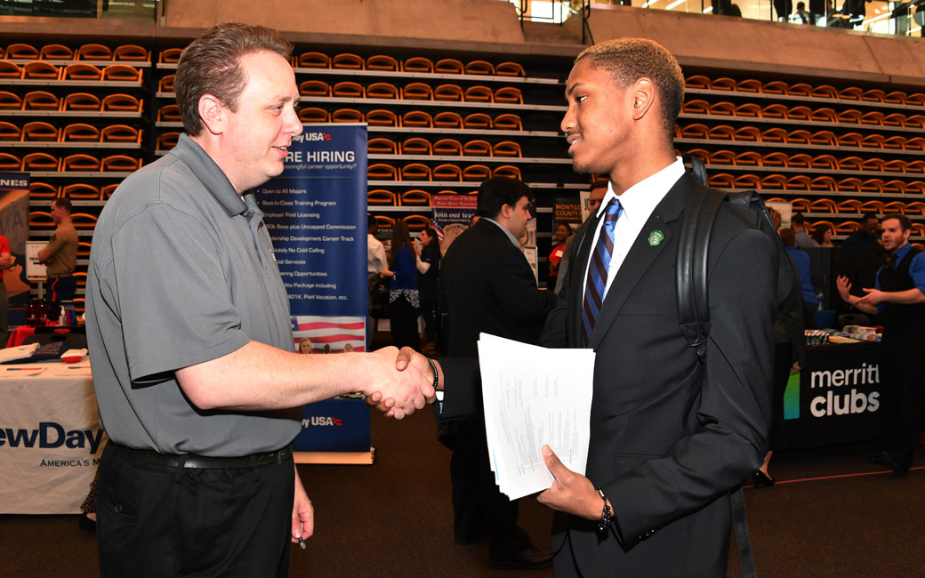 A student shaking hands with a potential employer