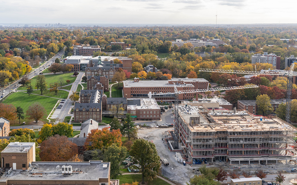 Building construction from the air with fall foliage