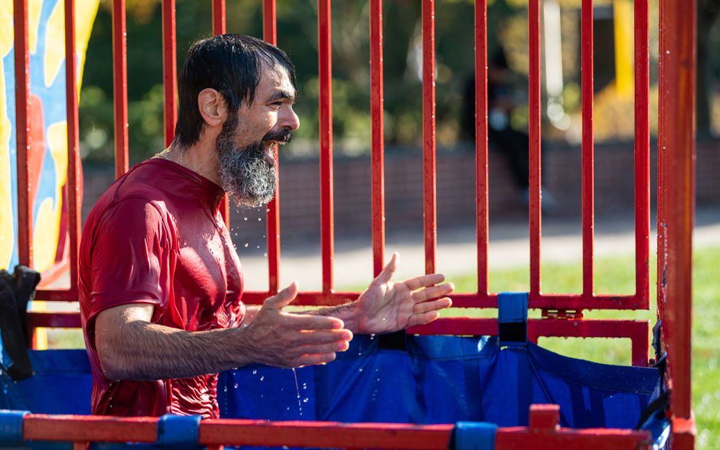 Anthony Skevakis, Associate Vice President for Student Affairs and Dean of Students, reacts to being dunked in a dunk tank during the block party