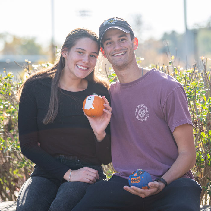 A couple shows off their painted pumpkins from the Block Party