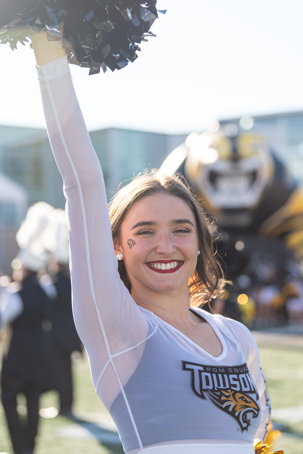 Towson pom squad member smiling for the camera 