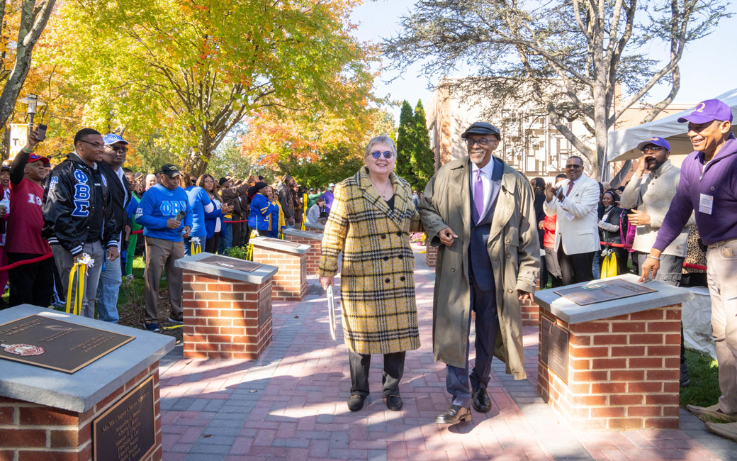 President Kim Schatzel and Dr. Julius Chapman, TU's first dean of minority affairs, walk through the newly dedicated NPHC Tribute Walkway