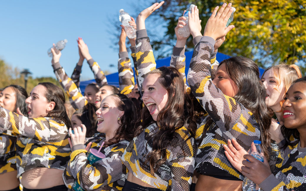 Members of TU Dance Team wave to the crowd after a performance during the pre-game ceremonies