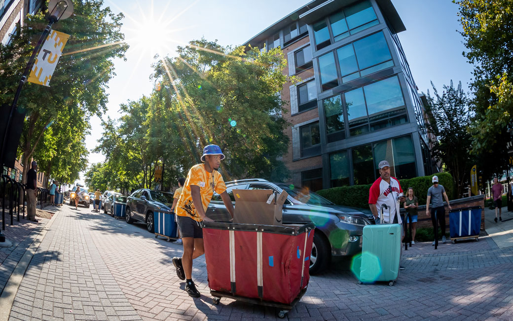 Move-In Crew pushing a cart through campus