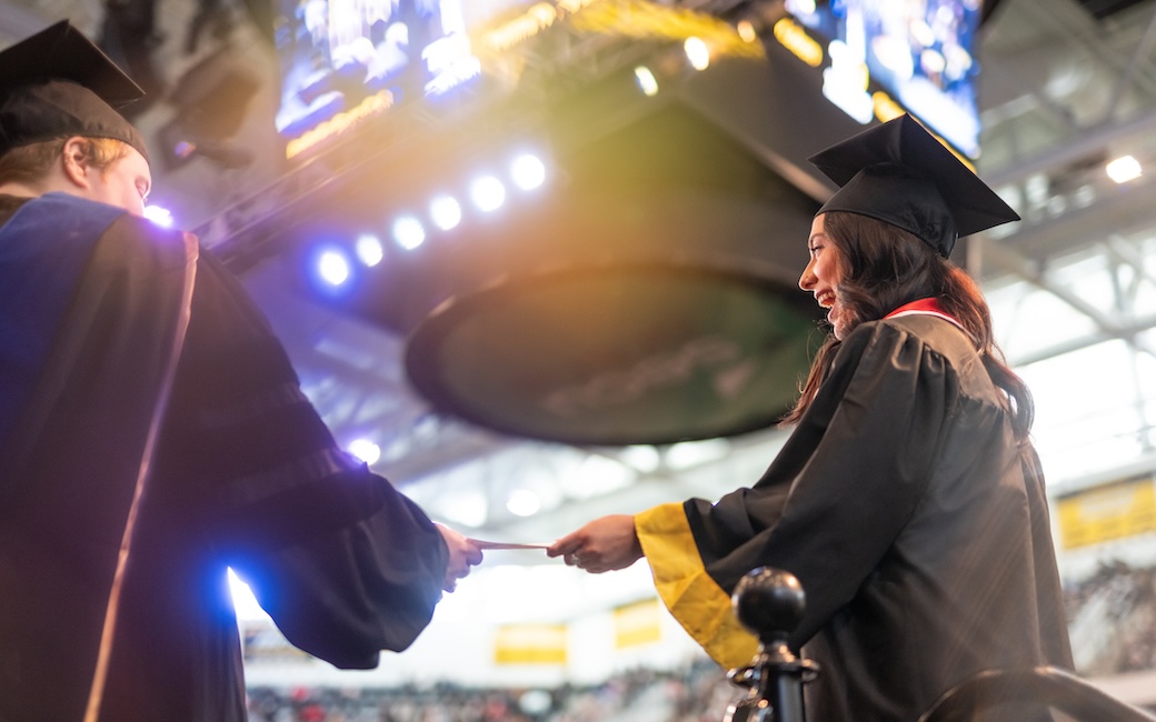 Graduate about to walk across stage at CHP & CBE ceremony