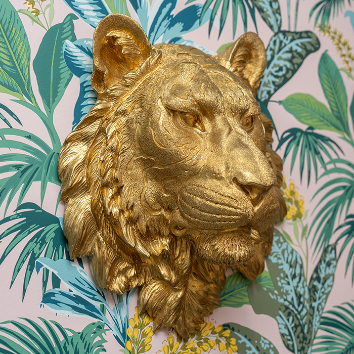 Gold tiger head sculpture mounted to a wall